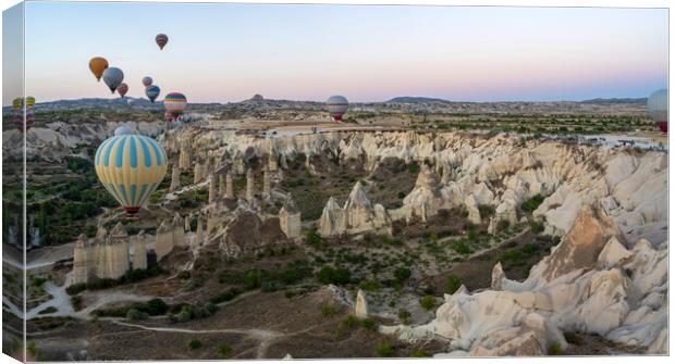 Hot Air balloons flying tour over Mountains landscape geological rock formation in autumn during sunrise in Cappadocia, Goreme National Park, Turkey nature background Canvas Print by Arpan Bhatia