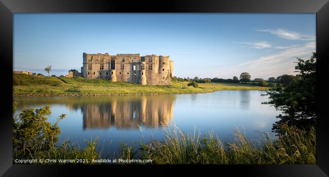 Carew Castle reflected by the evening sun  Framed Print by Chris Warren