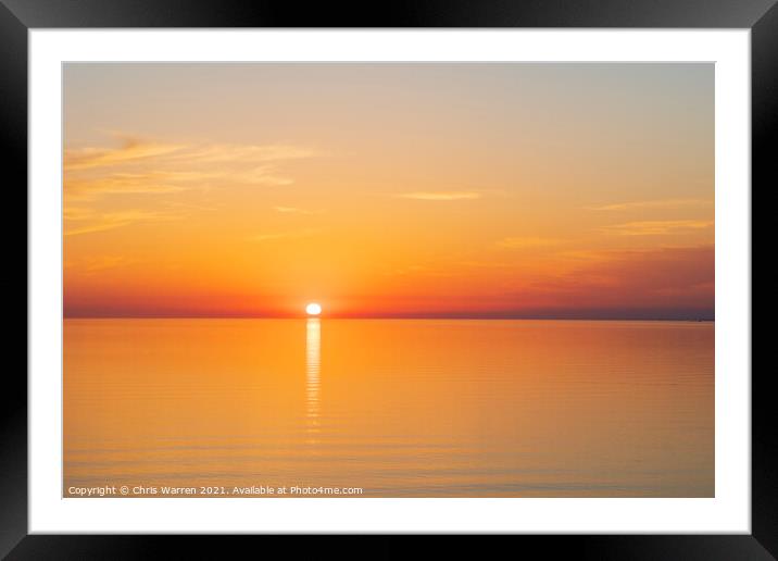 Sun setting over a calm sea Framed Mounted Print by Chris Warren