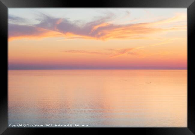 Sunset clouds over a calm sea Framed Print by Chris Warren