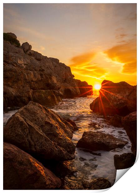 Sunrise between the rocks in a cove of La Renega, Oropesa Print by Vicen Photo