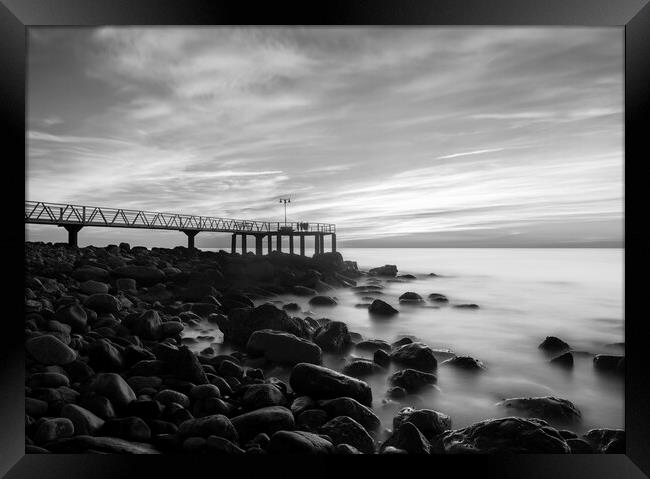 Sunrise next to a rocky beach in black and white Framed Print by Vicen Photo
