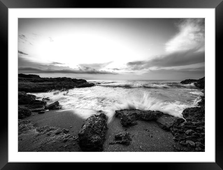 A wave crashing against the rock on a beach in black and white Framed Mounted Print by Vicen Photo
