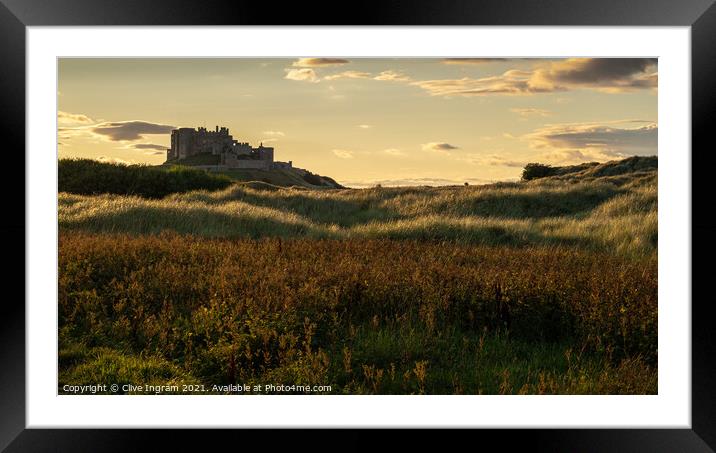 Majestic Bamburgh Castle at Golden Hour Framed Mounted Print by Clive Ingram