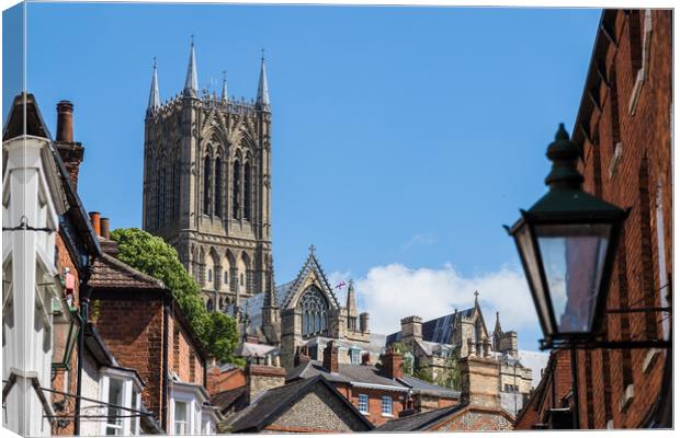 Lincoln cathedral peaking above the rooftops of the city Canvas Print by Jason Wells