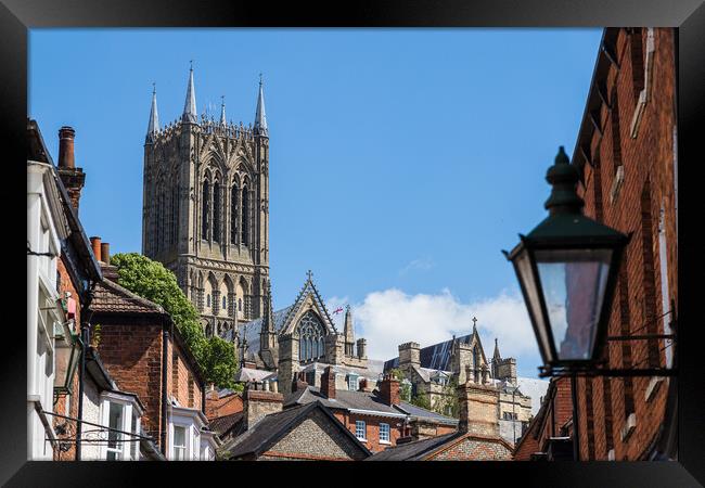Lincoln cathedral peaking above the rooftops of the city Framed Print by Jason Wells
