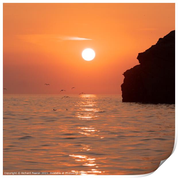 Warm orange sunset reflecting off the sea at South Print by Richard Fearon
