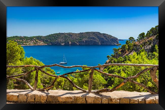 Idyllic bay with sailboat at blue sea Framed Print by Alex Winter