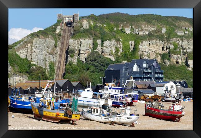 Hastings Beach - Fishing Huts  and boats  Framed Print by Phil Banks