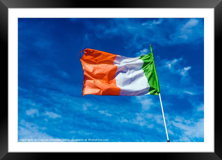Flag of italy waving against the blue sky with clouds. Framed Mounted Print by Joaquin Corbalan