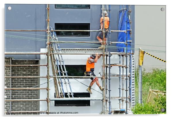 Construction workers dismantling scaffolding on new construction Acrylic by Geoff Childs