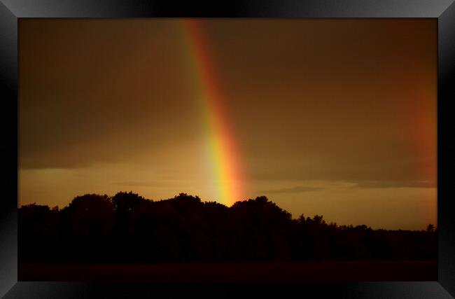 storm light and rainbow Framed Print by Simon Johnson