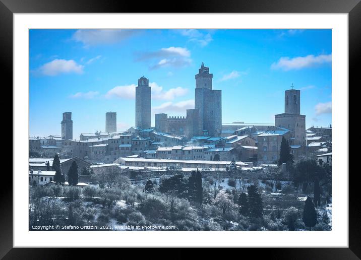 San Gimignano town skyline after a snowfall. Tuscany, Framed Mounted Print by Stefano Orazzini