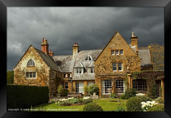 Coton Manor with approaching storm Framed Print by Keith Bowser