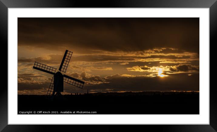 Windmill silhouette at dusk Framed Mounted Print by Cliff Kinch