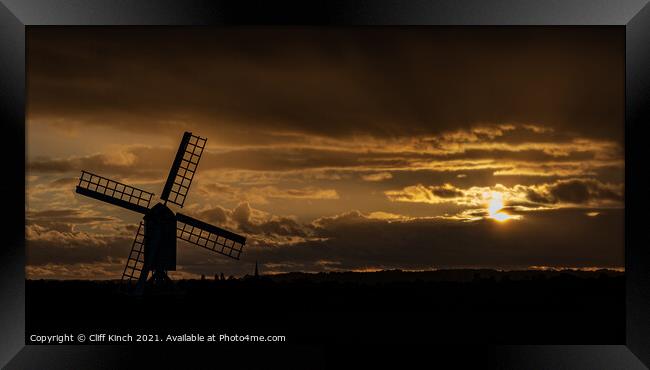 Windmill silhouette at dusk Framed Print by Cliff Kinch