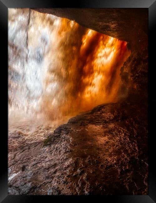 Standing behind A large waterfall in a cave Framed Print by simon cowan