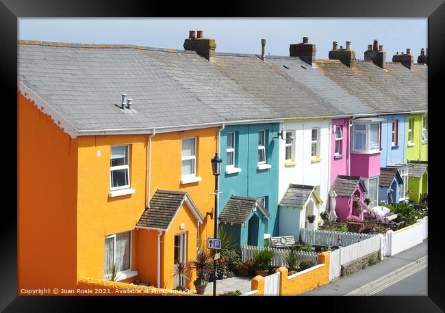 Row of brightly coloured houses in a street in Westward Ho! Framed Print by Joan Rosie