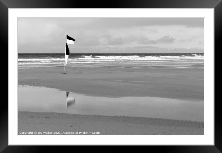 Yellow and red beach safety flag on a Cornish beach in black and Framed Mounted Print by Joy Walker