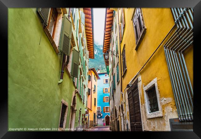 Narrow and colorful streets in a typical Italian village on the  Framed Print by Joaquin Corbalan