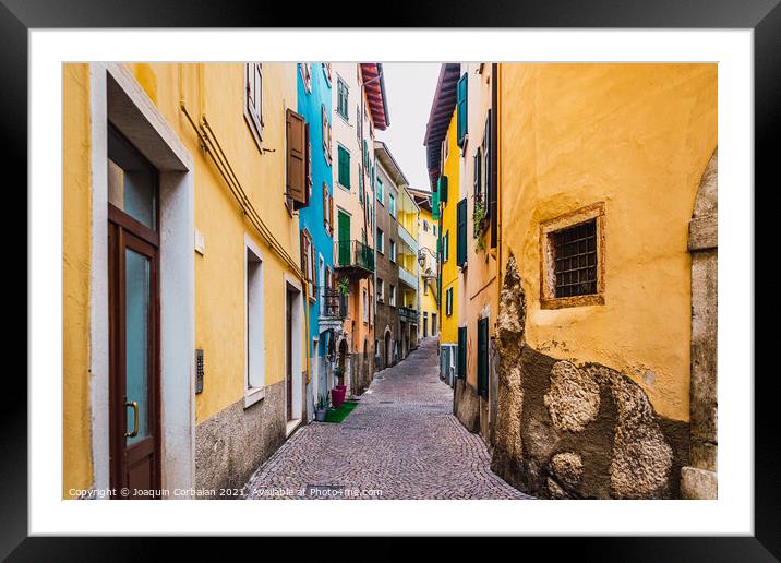 Old and narrow streets of beautiful typical Italian colors on a  Framed Mounted Print by Joaquin Corbalan