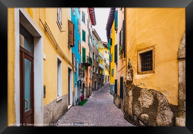 Old and narrow streets of beautiful typical Italian colors on a  Framed Print by Joaquin Corbalan