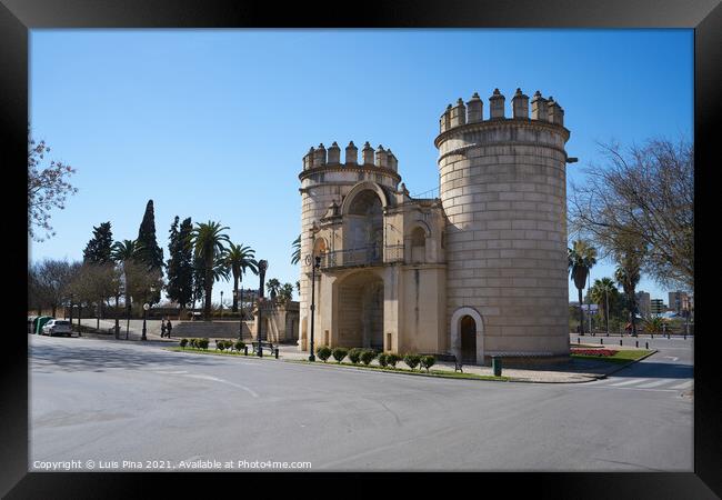 Puerta de Palmas entrance towers on a middle of a road in Badajoz, Spain Framed Print by Luis Pina