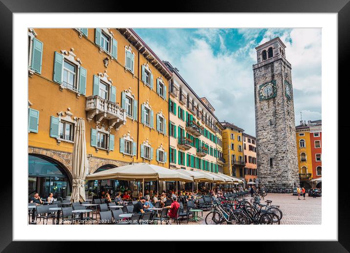Riva del garda, italy - october 2, 2021: Tourists relax on the t Framed Mounted Print by Joaquin Corbalan