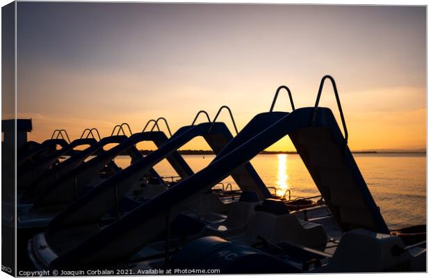 Silhouette of water scooters parked on the shore at the end of t Canvas Print by Joaquin Corbalan