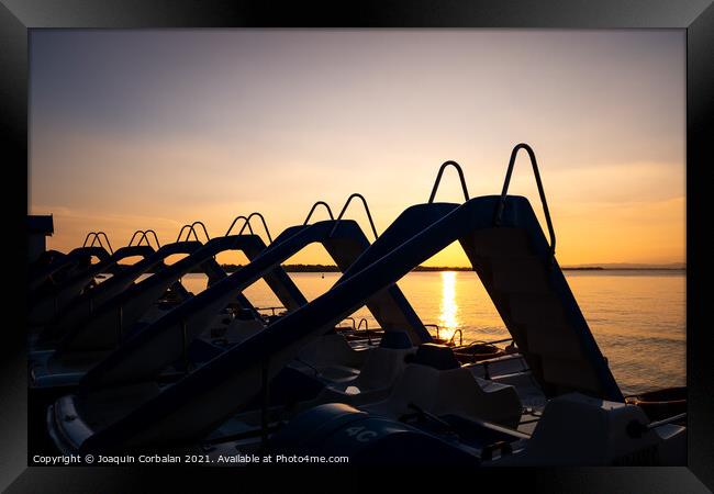 Silhouette of water scooters parked on the shore at the end of t Framed Print by Joaquin Corbalan