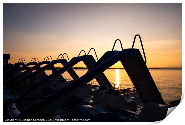 Silhouette of water scooters parked on the shore at the end of t Print by Joaquin Corbalan