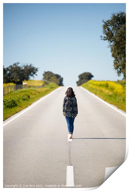 Woman walking on the middle of a road in beautiful yellow flowers landscape in Alentejo, Portugal Print by Luis Pina