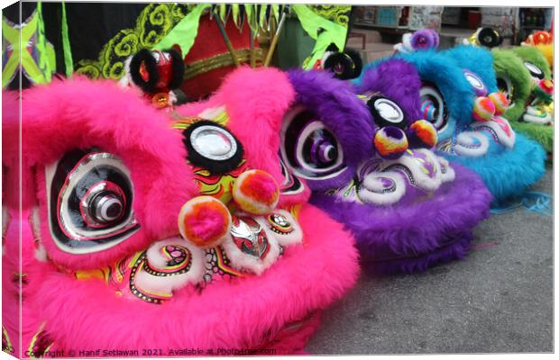 Chinese Dragon masks in three colors on a festival Canvas Print by Hanif Setiawan