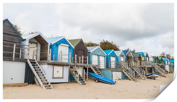 Abersoch beach huts lined up Print by Jason Wells