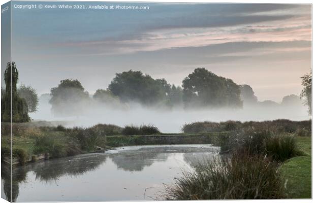 Pond bridge in morning mist Canvas Print by Kevin White