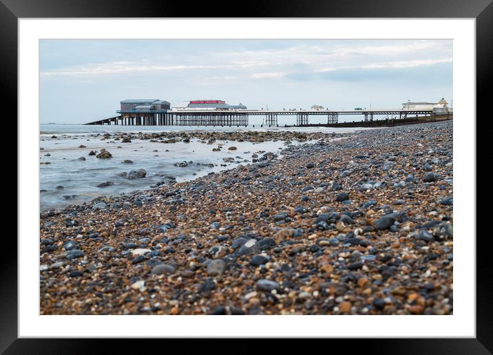 Cromer Pier seen over the shingle beach Framed Mounted Print by Jason Wells