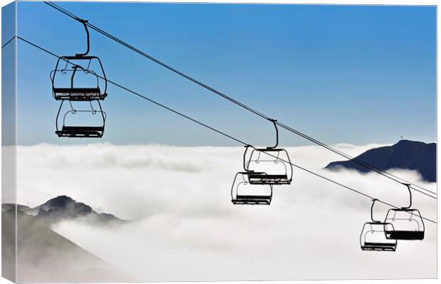 Empty Chairlift above the Clouds Canvas Print by Arterra 