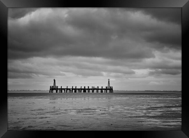 Old Pier under cloud Framed Print by David McCulloch