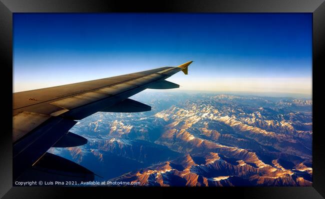 View from Airplane Window on a mountain landscape with snow and airplane wing Framed Print by Luis Pina