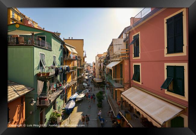 Colorful Manarola street full of tourists in Cinque Terre, Italy Framed Print by Luis Pina