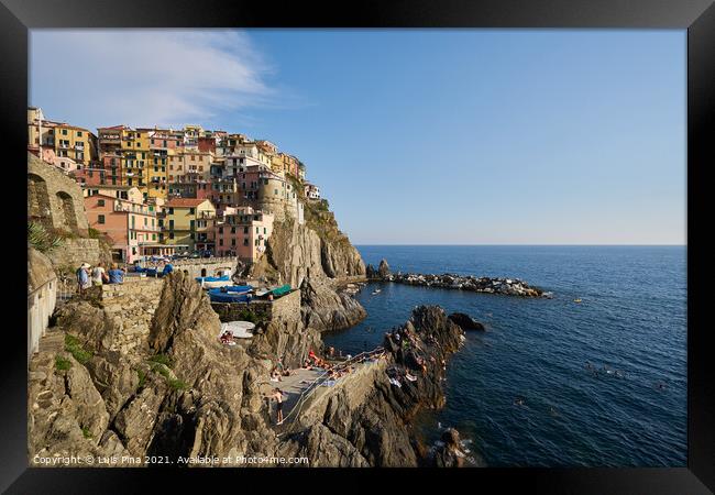 Manarola beach and city view in Cinque Terre, in Italy Framed Print by Luis Pina