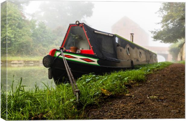 Moored narrow boat in the mist. Canvas Print by Clive Wells