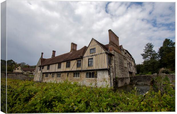 Ightham Mote under a cloudy sky  Canvas Print by Fiona Etkin