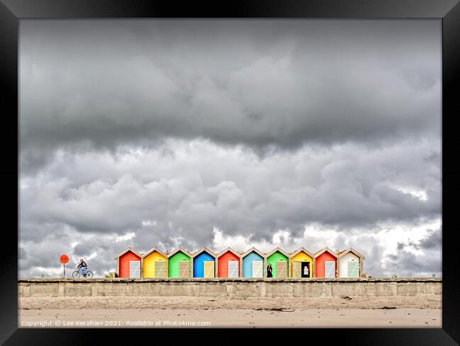 Stormy clouds over beach huts Framed Print by Lee Kershaw