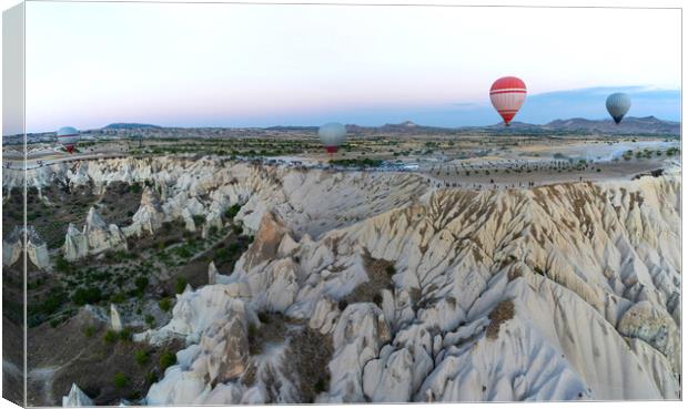 Wide angle view of hot air balloons against unique geological fo Canvas Print by Arpan Bhatia