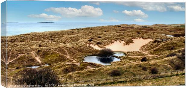 Bamburgh Beach With Holy Island In The Background Canvas Print by Kevin Maughan