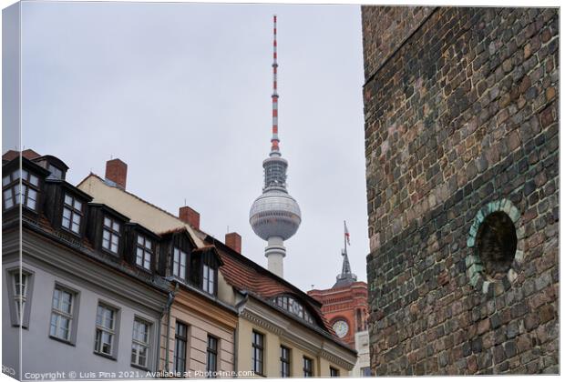 Berlin TV Tower on a cloudy day seen from Nikolaikirche Church Canvas Print by Luis Pina