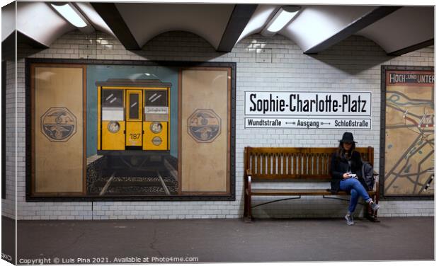 Woman sitting on a bench at Sophie Charlotte Platz subway station in Berlin Canvas Print by Luis Pina
