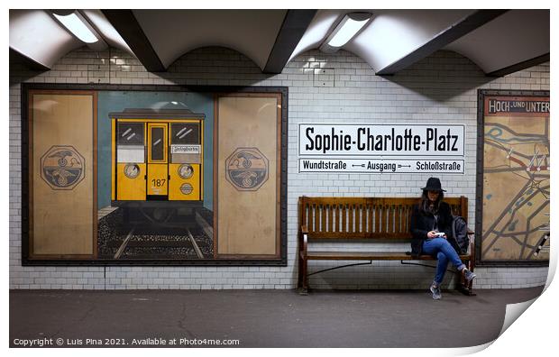 Woman sitting on a bench at Sophie Charlotte Platz subway station in Berlin Print by Luis Pina