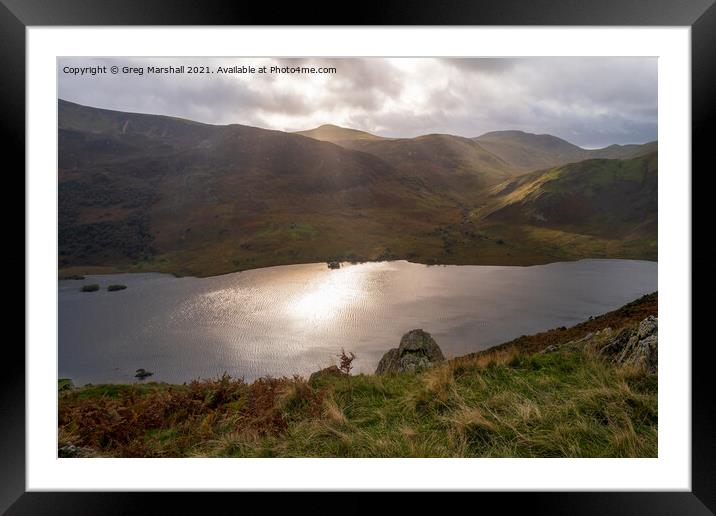 Sun breaks over icy looking Crummock Water from Rannerdale Knotts Framed Mounted Print by Greg Marshall